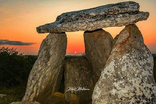 Otra imagen del atardecer. En primer plano podemos ver el dolmen de Sorginetxe (Arrízala), correspondiente a la edad del hierro y con una antigüedad de unos 4500 años aproximadamente. En el fondo se encuentra el sol, lejano, muy pequeño, como un pequeño punto brillante, enmarcado en un hueco de la construcción, un hueco entre las grandes piedras que hacen de "patas" para sustentar la enorme losa del "techo", uno de los marcos más antiguos que puede haber, más de 4500 años.